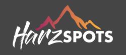 Logo Harzspots, Wort und stilisierter Berg imm Hintergrund.